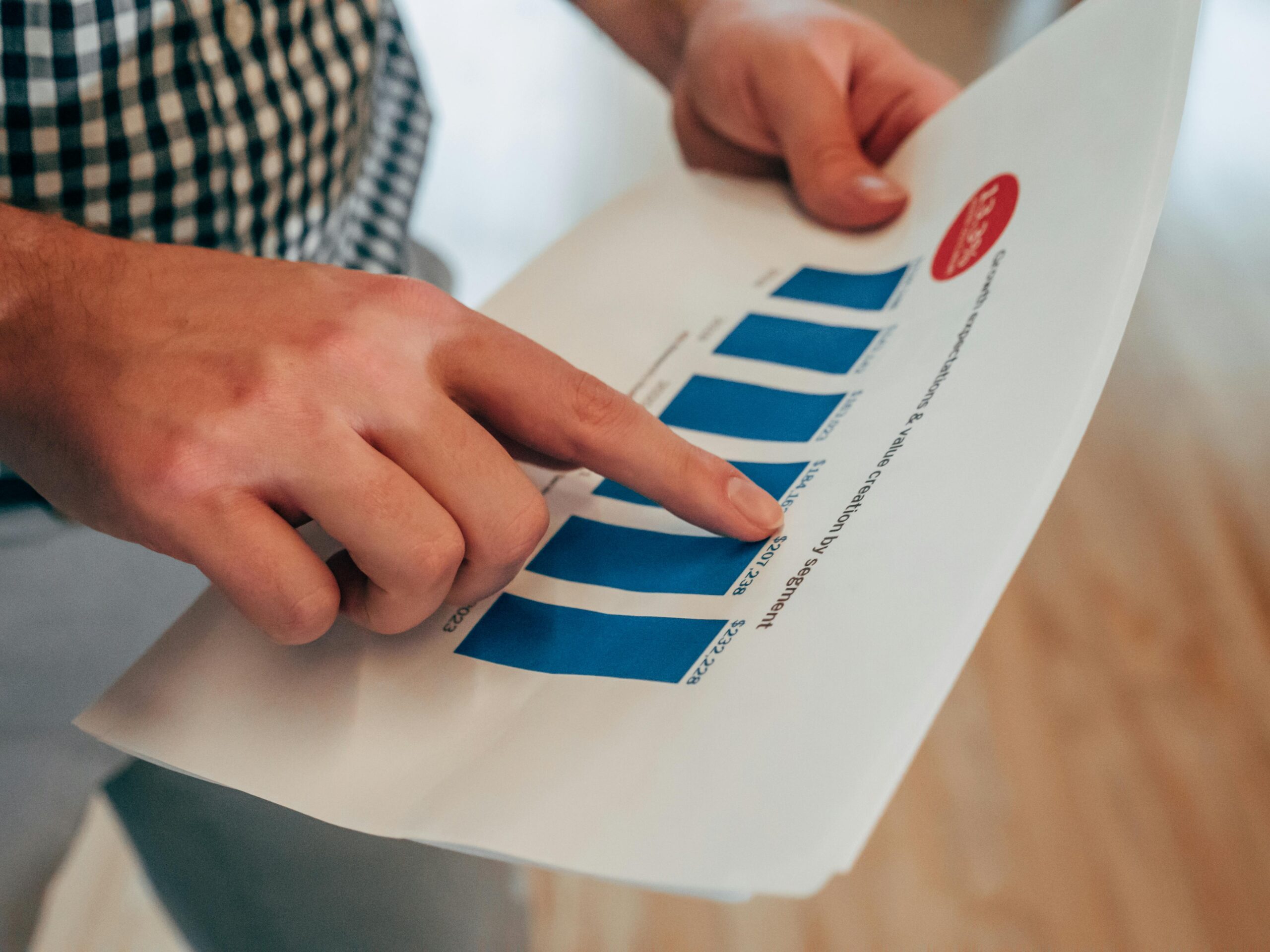 Image of businessman's hands reviewing sales data.