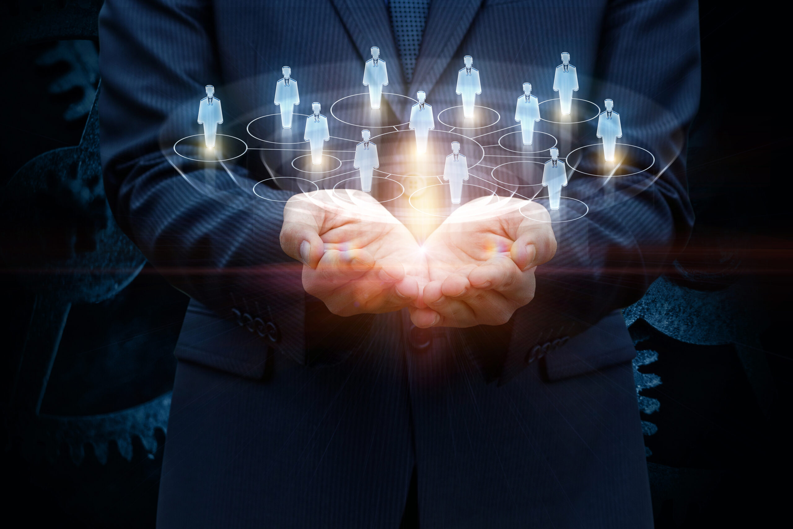 Image of professional man holding a team of people in parm of his hands